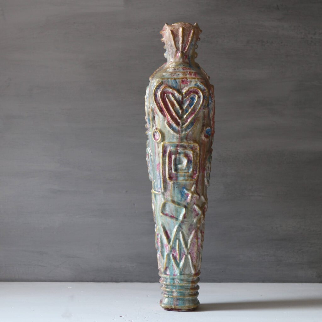 Vertical Wabi-sabi sculptural vase with heart and spiral patterns.