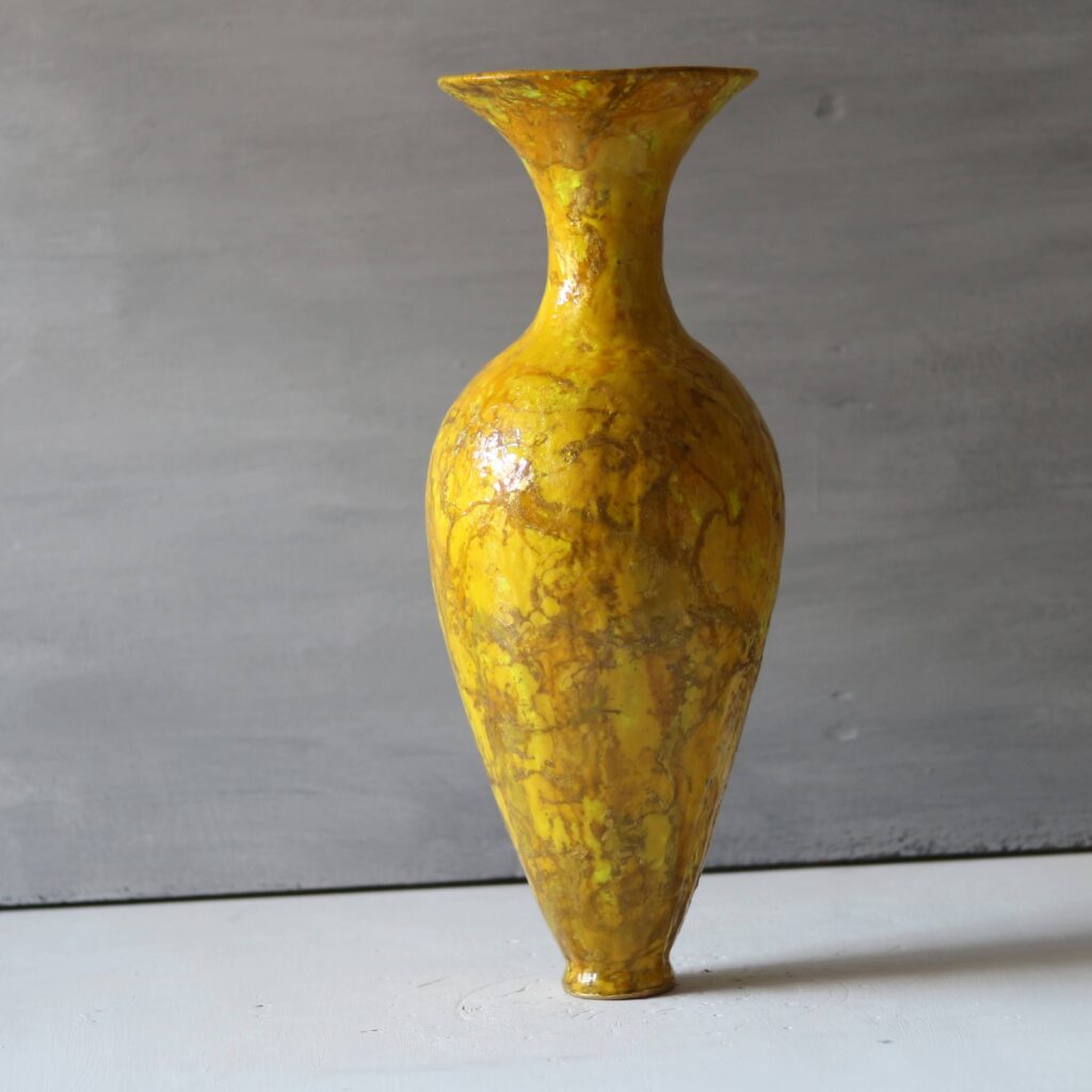 Ancient-inspired yellow and gold sculptural vase, luxury mineral clay art.
