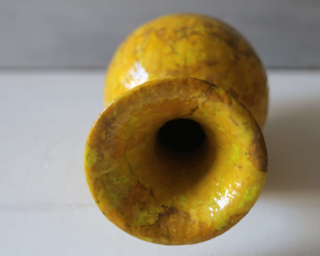 Close-up of golden brown textured art vase, signature mineral-base craft.